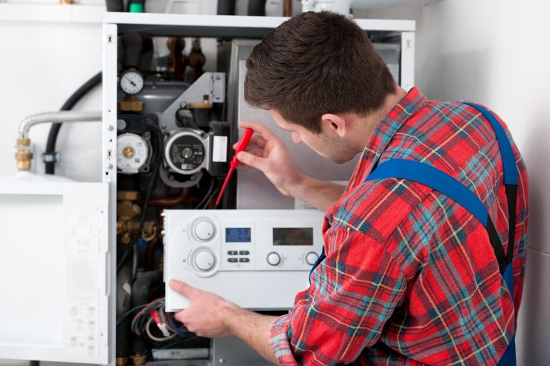 Gas Safe engineer working on a boiler in Brent Cross